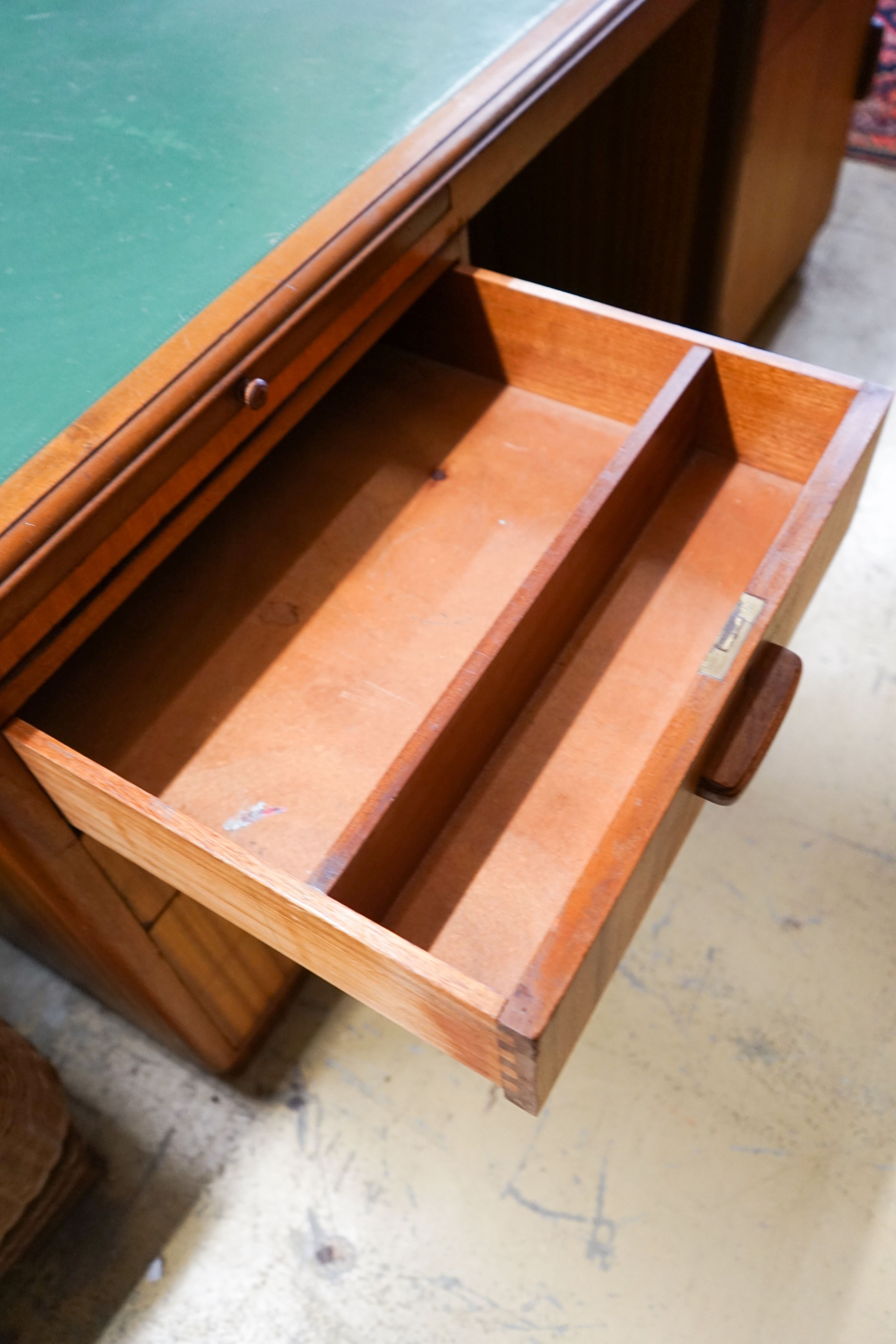 A mid century design teak kneehole desk, bears a Waring & Gillow stamp, length 168cm, depth 106cm, height 74cm